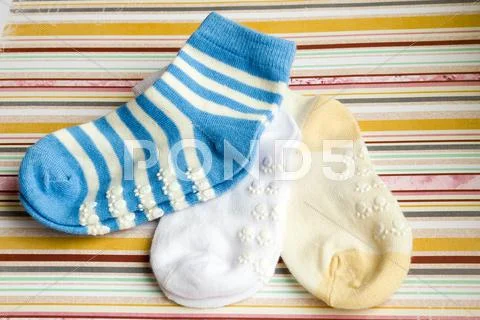Kids Bright Background With Three Baby Socks With Copy Space For Your Message