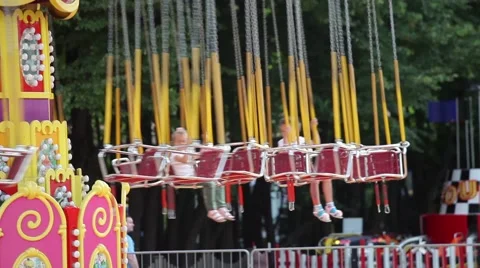 Kids on carousel in amusement park Stock Footage 64754778