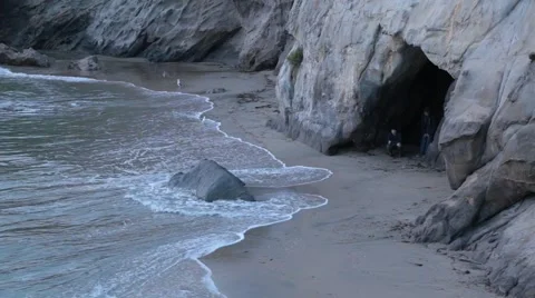 Kids In A Cave At The Beach Stock Footage 64216394