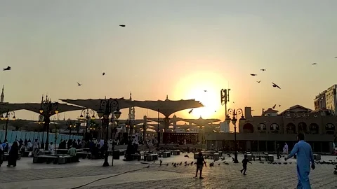 Kids chasing doves against the backdrop of the Prophet's Mosque Video stock 230374327