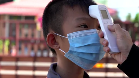 Kids checking body temperature by infrared thermometer for protect and safety Vidéo 132590637