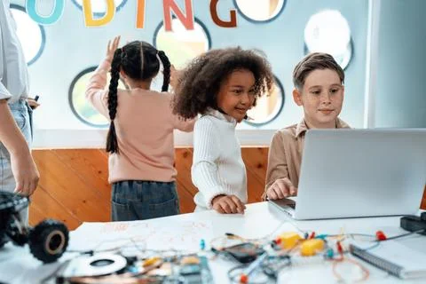 Kids in classroom learning about programming remote car with laptop. Erudition. 스톡 사진