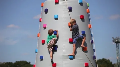 Kids climb on climbing wall Stock Footage 74546253