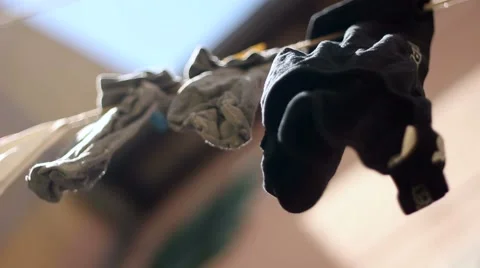 Kids clothes drying on wire under the sun Stock-Footage 47323238