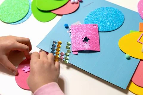 Kids creative easter craft making diy paper egg decorations. Stock Photos