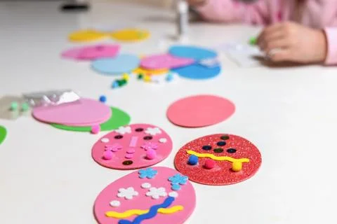 Kids creative easter craft making diy paper egg decorations. Stock Photos