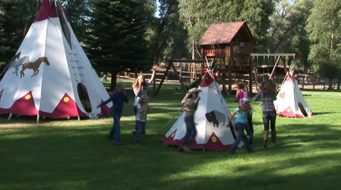 KIDS DANCING AROUND THE TEE PEE Stock Footage 33832190