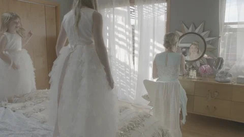 Kids dancing on bed while mother applying lip balm on lips in bedroom Stock Footage 99998622