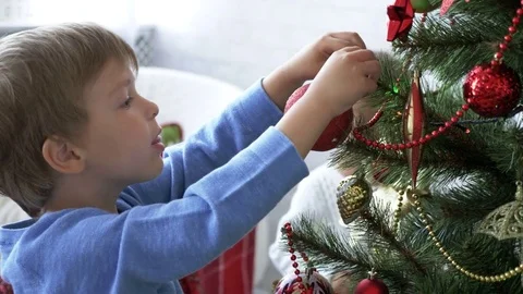 Kids decorating Christmas tree in light room at daytime Stock Footage 76916804