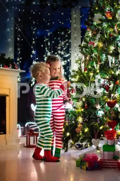 Kids decorating Christmas tree Stock Photos