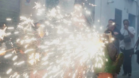 Kids dressed as Correfoc dragons spraying fireworks in Barcelona Spain Stock Footage 100389836