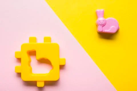Kids educational developing toys frame on colorful background. Top view. Flat Stock Photos