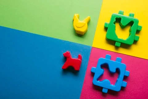 Kids educational developing toys frame on colorful background. Top view. Flat Foto stock