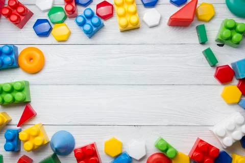 Kids educational developing toys frame on white background. Top view. Flat lay Stock Photos