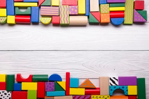 Kids educational developing toys frame on white background. Top view. Flat lay Stock Photos