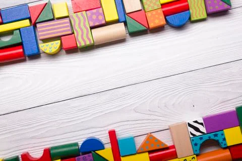 Kids educational developing toys frame on white background. Top view. Flat lay Stock Photos