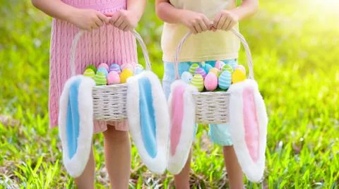 Kids with eggs basket on Easter egg hunt. Stock-Fotos