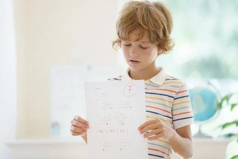 Kids fail math test in school. Child after exam. Stock Photos