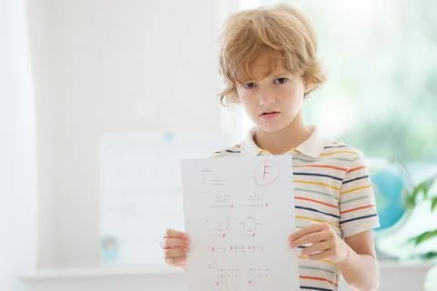 Kids fail math test in school. Child after exam. Stock Photos