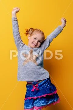 Kid's fashion. Portrait of a cute six year old girl wearing knitted clothes p Stock Photos