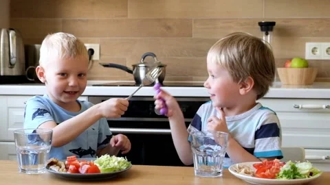 Kids fighting with falks in the kitchen Stock Footage 89837743