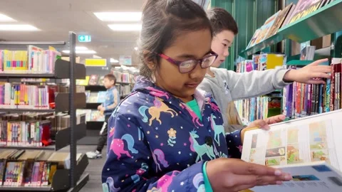 Kids Finding Books Stock Footage 327614451