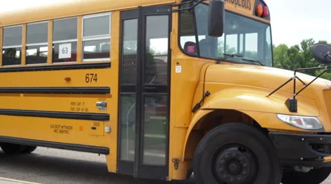 Kids getting off bus, walking to school Stock Footage 31040587