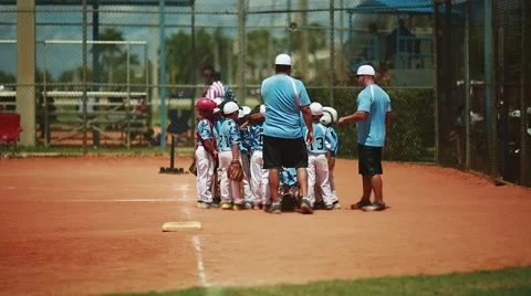 Kids getting instructions from coach at baseball game Stock Footage 51112551
