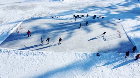 Kids getting ready to play some pond hockey on a frozen lake 4K footage Stock Footage 149081972