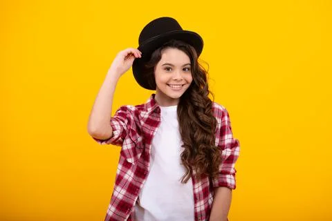 Kids girl in old fashion clothes. Elegent hat, cylinder hat isolated on yellow Stock Photos