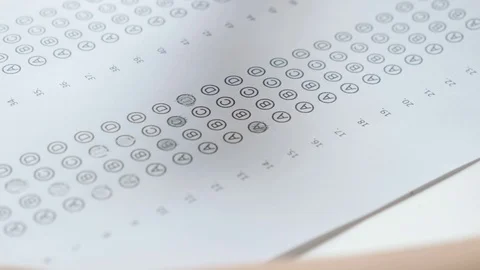 Kid's hand filling bubble test with a pencil, close up. Education and exams 動画素材 120134798
