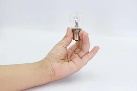 Kids hand holding a light bulb isolated on white background. Stock Photos