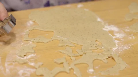 Kid's hand using Christmas tree shape mold to make cookies Stock Footage 105777910