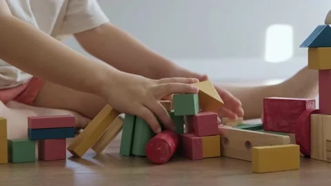 Kid's hands destroying construction from colored cubes. Children build toy house Stock Footage 170872049