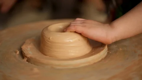 Kid's hands at pottery workshop. Creating pottery product with dirty hands on Stock Footage 107468815