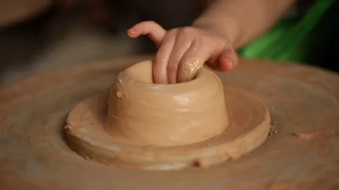 Kid's hands at pottery workshop. Creating pottery product with dirty hands on Stock Footage 107468868
