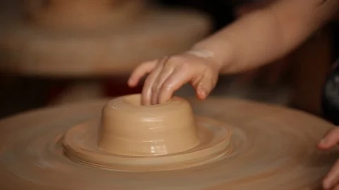 Kid's hands at pottery workshop. Creating pottery product with dirty hands on Stock Footage 107468931
