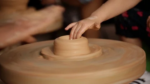 Kid's hands at pottery workshop. Creating pottery product with dirty hands on Stock Footage 107468971