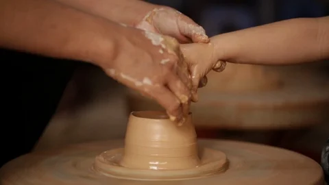 Kid's hands at pottery workshop. Creating pottery product with dirty hands on Stock Footage 107468991