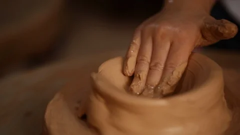 Kid's hands at pottery workshop. Creating pottery product with dirty hands on Stock Footage 107469269