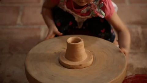 Kid's hands at pottery workshop. Creating pottery product with dirty hands on Stock Footage 107469390