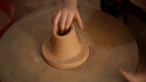 Kid's hands at pottery workshop. Creating pottery product with dirty hands on Stock Footage 107469391