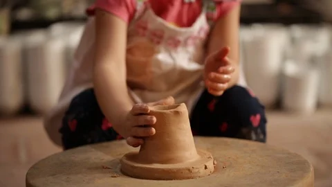 Kid's hands at pottery workshop. Creating pottery product with dirty hands on Stock Footage 107469396