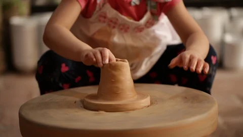Kid's hands at pottery workshop. Creating pottery product with dirty hands on Stock Footage 107469446