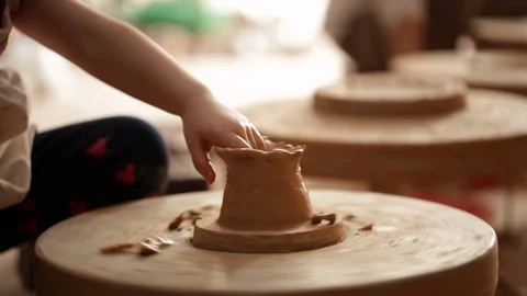 Kid's hands at pottery workshop. Creating pottery product with dirty hands on Stock Footage 107469564