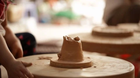 Kid's hands at pottery workshop. Creating pottery product with dirty hands on Stock Footage 107469571