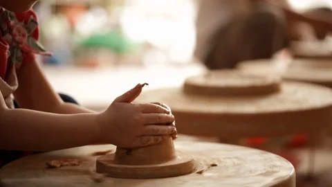 Kid's hands at pottery workshop. Creating pottery product with dirty hands on Stock Footage 107469605