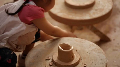 Kid's hands at pottery workshop. Creating pottery product with dirty hands on Stock Footage 107469646