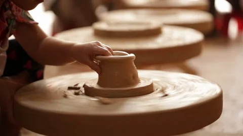Kid's hands at pottery workshop. Creating pottery product with dirty hands on Stock Footage 107469654