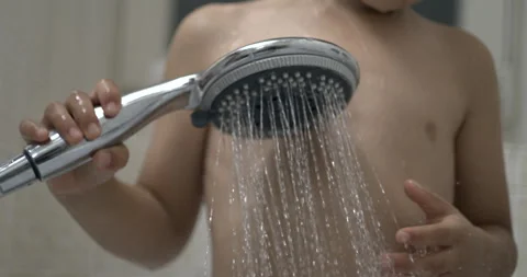 Kid's hands on shower during 800 fps slow-motion bath, water stream moment Stock Footage 250201585